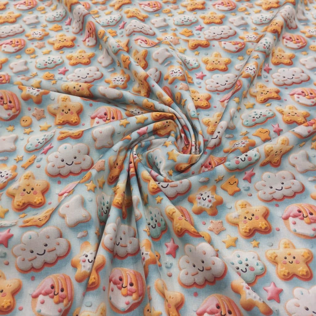 Algodon 3D con estampado de galletas con caritas sonrientes en fondo celeste