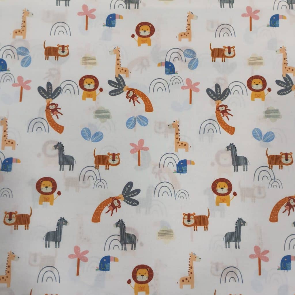 Tela de algodón con estampado infantil de animalitos de la selva, leones, jirafas, tigres y palmeras en tonos suaves. Ideal para costura y confección creativa.