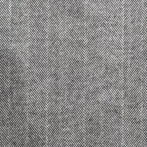 Paño gris espigado con textura clásica en espiga, ideal para confección de prendas elegantes.