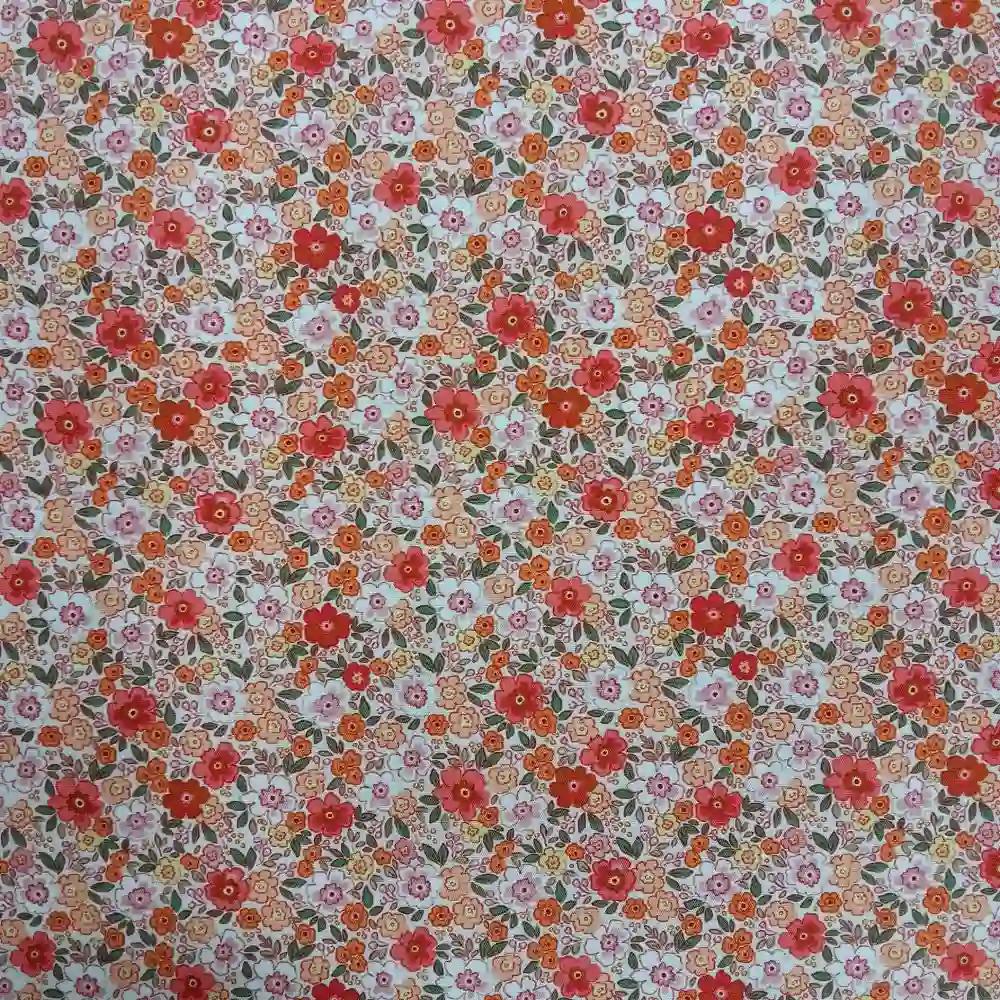 Tela de algodón con estampado floral de pequeñas flores naranjas