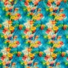 tela-algodon-estampado-flores-pensamientos-1 Tela de algodón con estampado de flores pensamientos en tonos turquesa, amarillo, rosa y naranja con pliegues suaves.