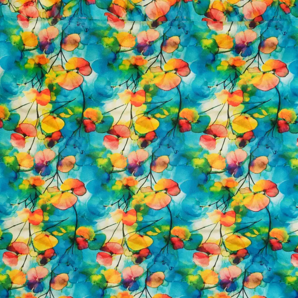 tela-algodon-estampado-flores-pensamientos-1 Tela de algodón con estampado de flores pensamientos en tonos turquesa, amarillo, rosa y naranja con pliegues suaves.