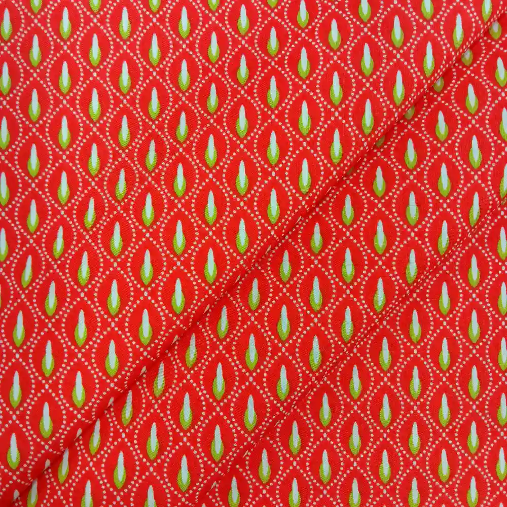 Tela de algodón naranja con estampado geométrico pistacho repetitivo