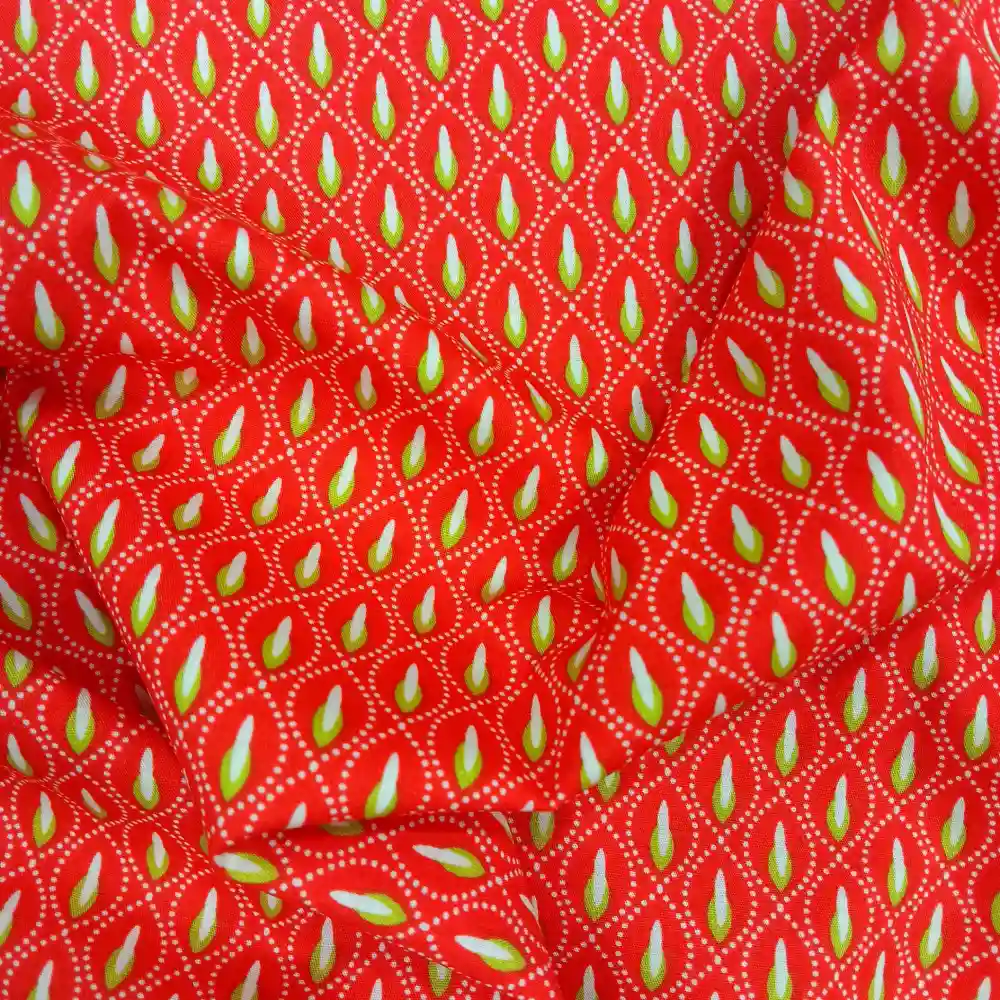 Tela de algodón naranja con estampado geométrico pistacho repetitivo