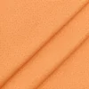 Tela de algodón naranja con estampado de pequeñas gotas