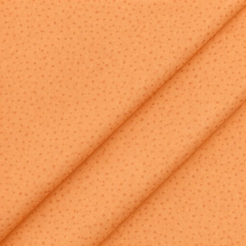 Tela de algodón naranja con estampado de pequeñas gotas
