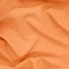Tela de algodón naranja con estampado de pequeñas gotas
