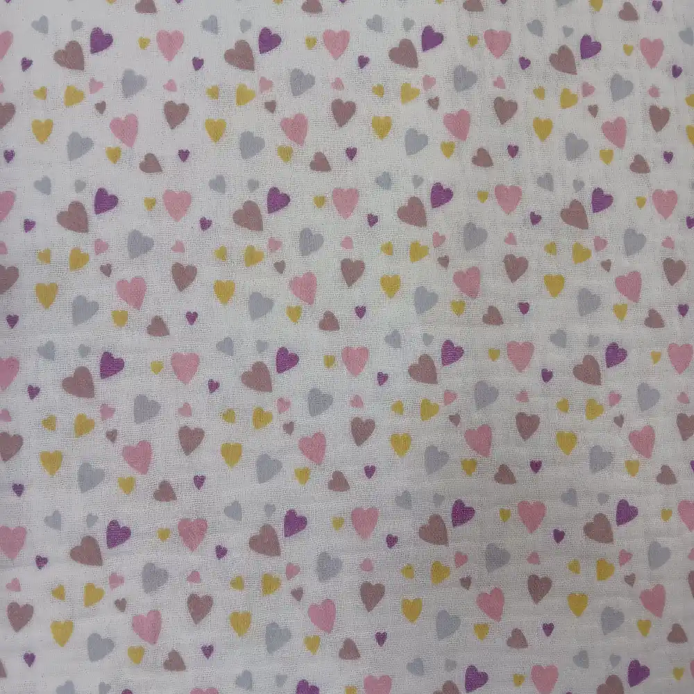 Tela de muselina con estampado de pequeños corazones de colores