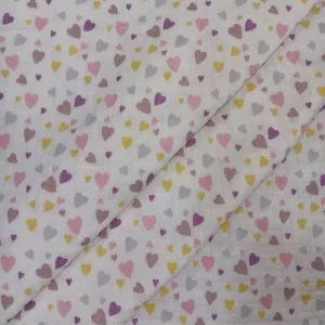 Tela de muselina con estampado de pequeños corazones de colores