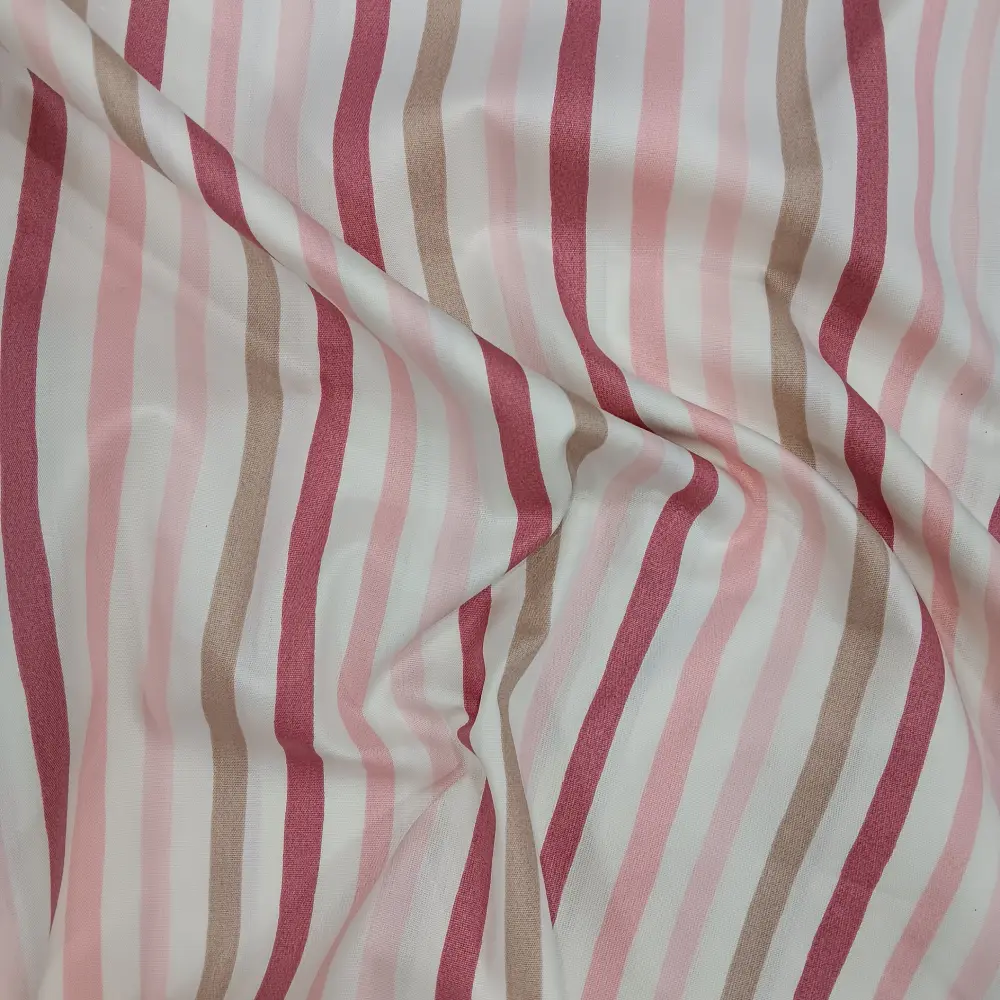 Tela de algodón con estampado de rayas verticales en tonos rosa, beige y blanco