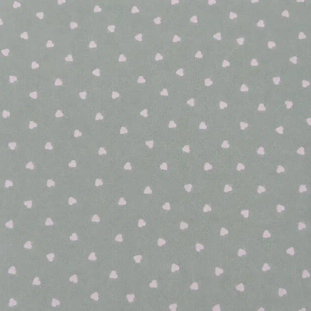 tela-algodon-estampada-verde-mint-corazones-blancos-1 Tela de algodón estampada verde mint con pequeños corazones blancos sobre fondo verde pastel.