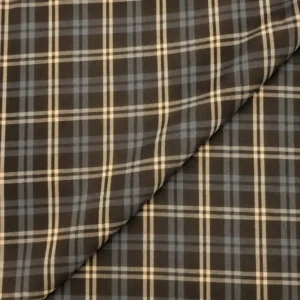 Tela cuadro grande marrón con estampado de líneas beige y gris azulado formando cuadros grandes.