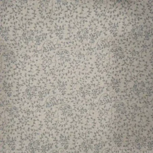 Tela de algodón aspecto lino en tono crudo, con textura de tejido visible y pequeños motivos irregulares de lúrex plateado distribuidos por la superficie.