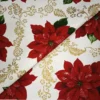 Tela de mantelería navideña con flores de Pascua y filigranas doradas - Thumbnail Image 2